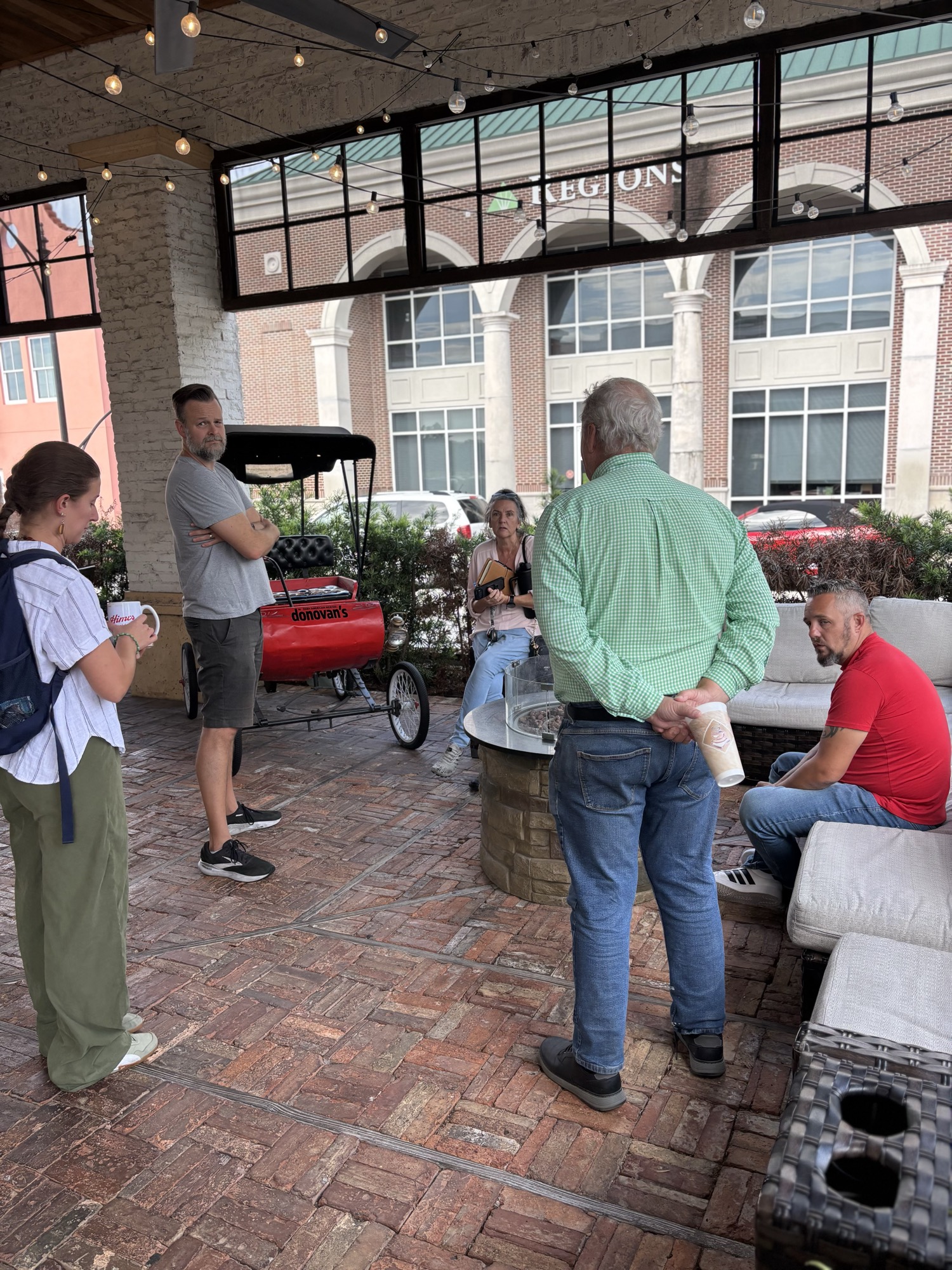 Winthrop restaurant owners gathered outdoors at Winthrop Town Centre with Donovan's Meatery pedicab in the background.